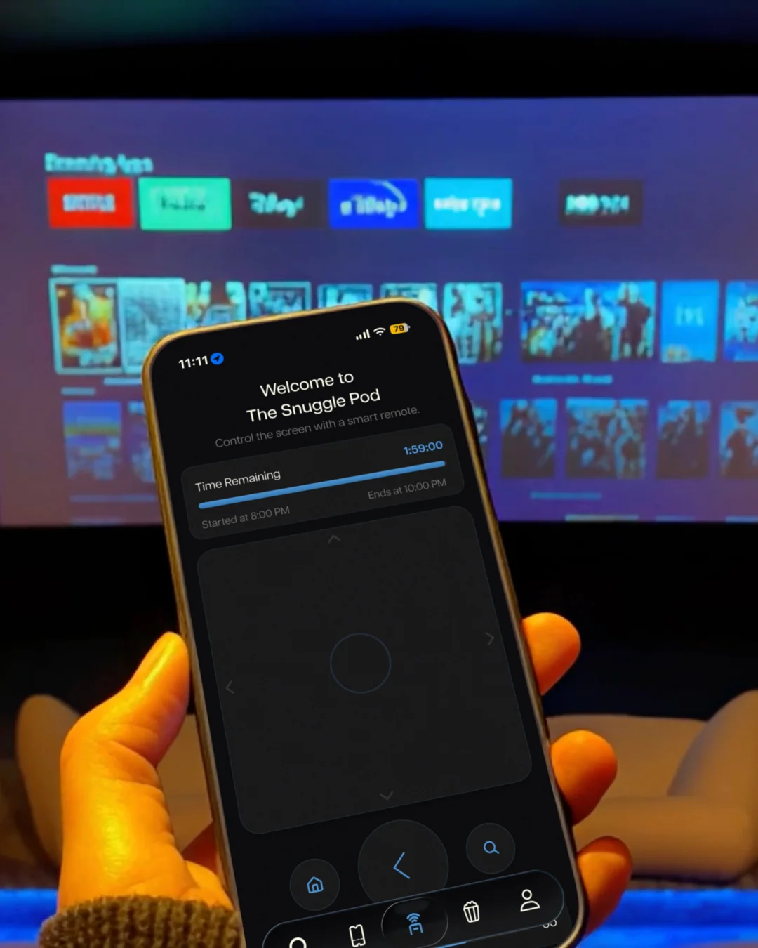 The smart remote on a phone, held up in front of the room’s screen